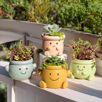 Pot de fleur extérieur en résine Ø 12 cm — visage souriant